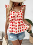 Woman wearing red heart print top with oversized bow