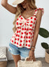 Woman smiling in sleeveless bow top with heart print