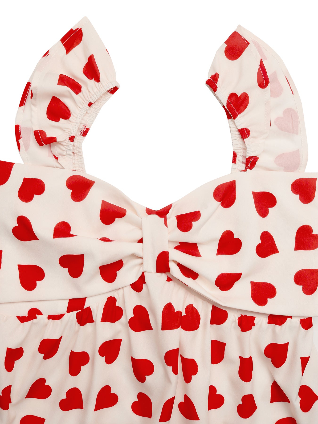 Close-up of bow and ruffle sleeve on heart print top