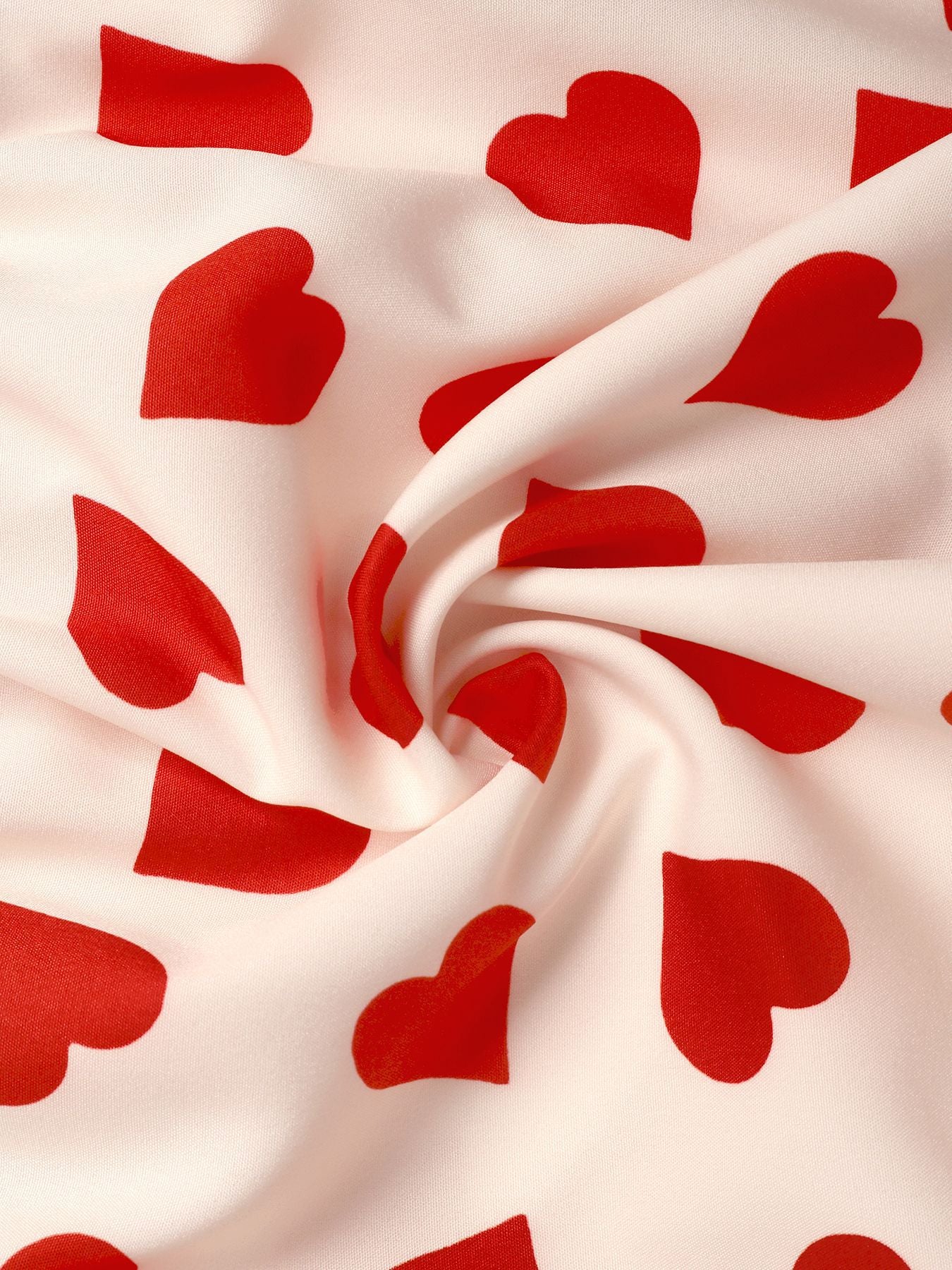 Close-up of red heart print fabric in soft swirl