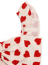 Close-up of ruffle shoulder strap on heart print top