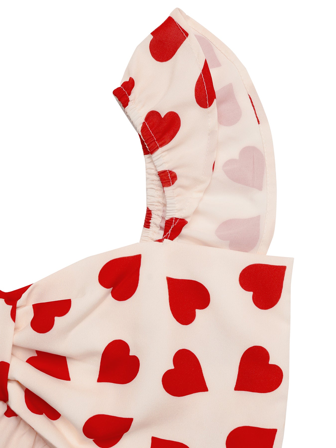 Close-up of ruffle shoulder strap on heart print top