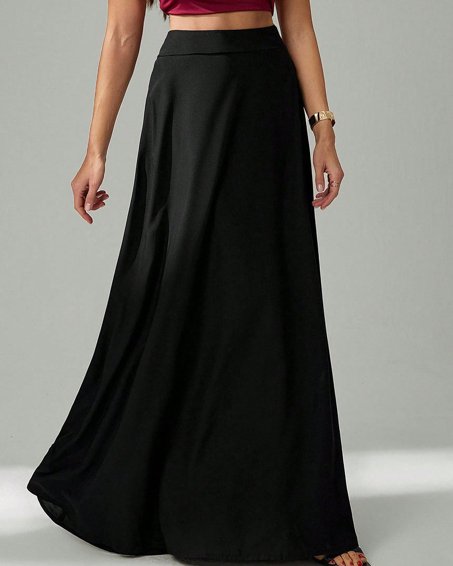 woman wearing a high-waist black long skirt standing with one hand relaxed