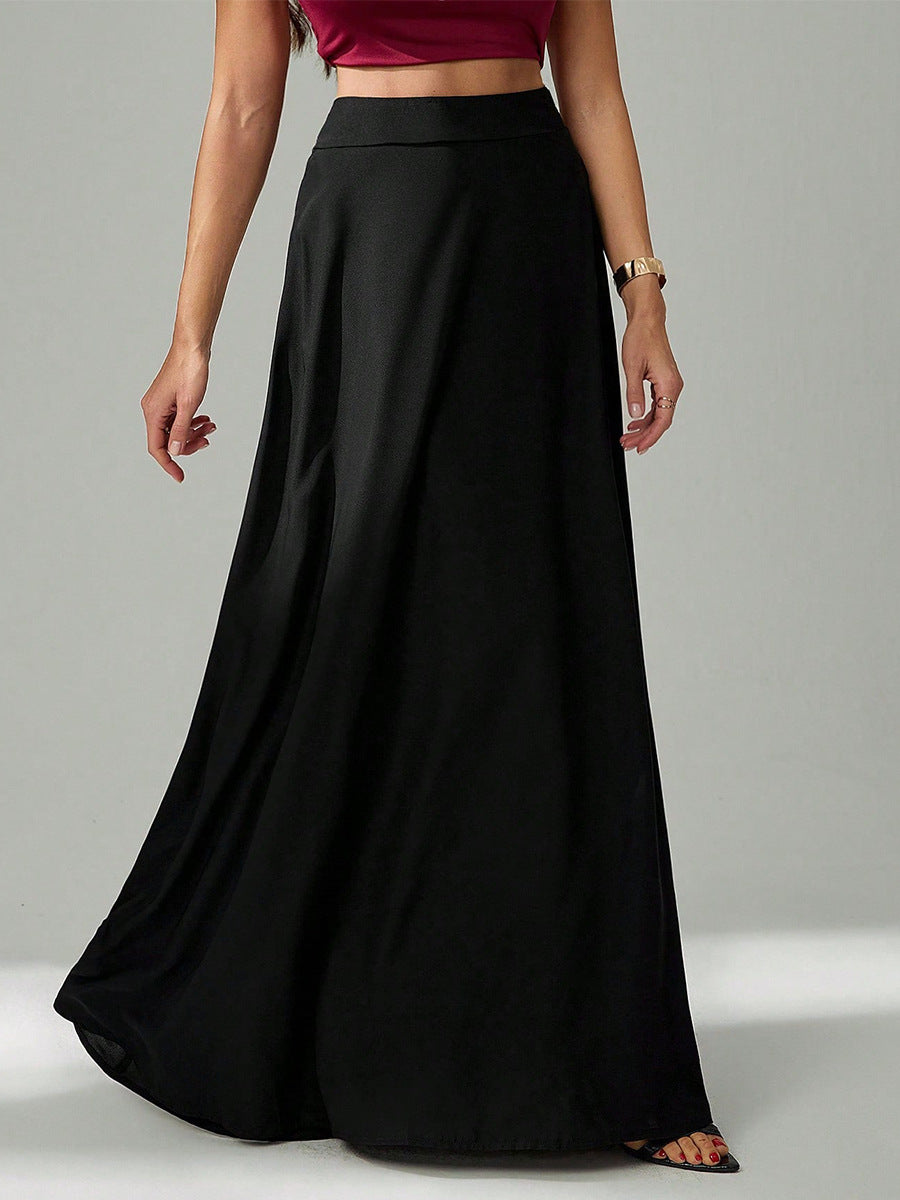 woman wearing a high-waist black long skirt standing with one hand relaxed