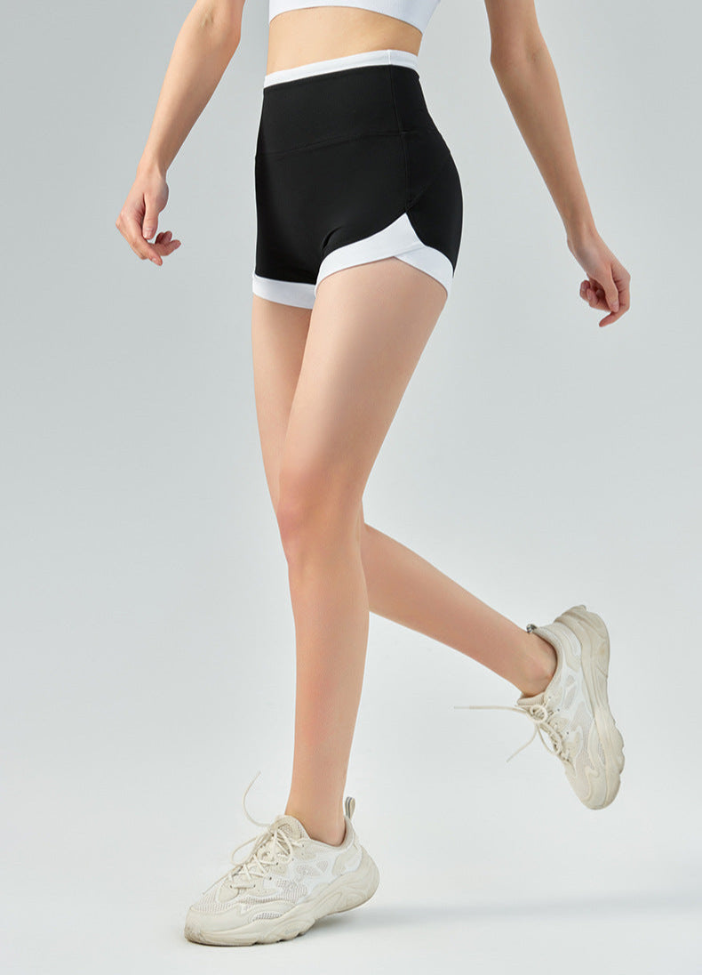 Model wearing high waisted black workout shorts with white trim, mid-stride.