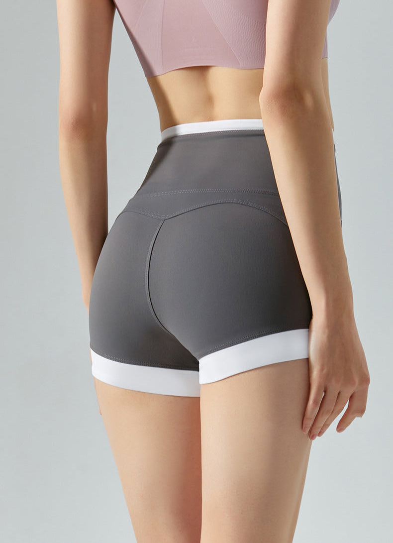  Rear view of gray high-rise shorts with curved white trim.
