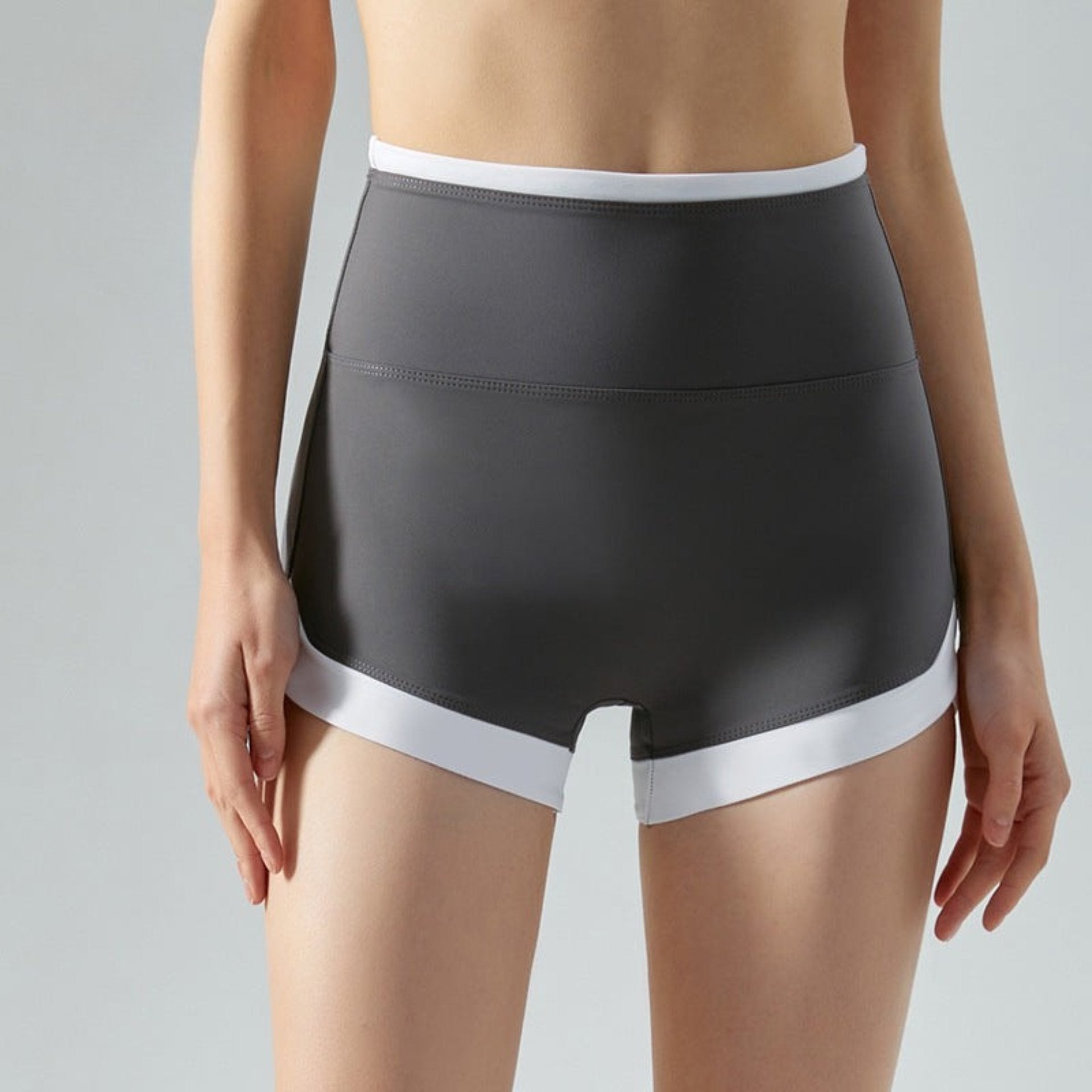 Gray high-rise workout shorts with white hem shown from front.