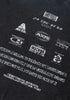 Angled back print detail highlighting layered logos and faded text.