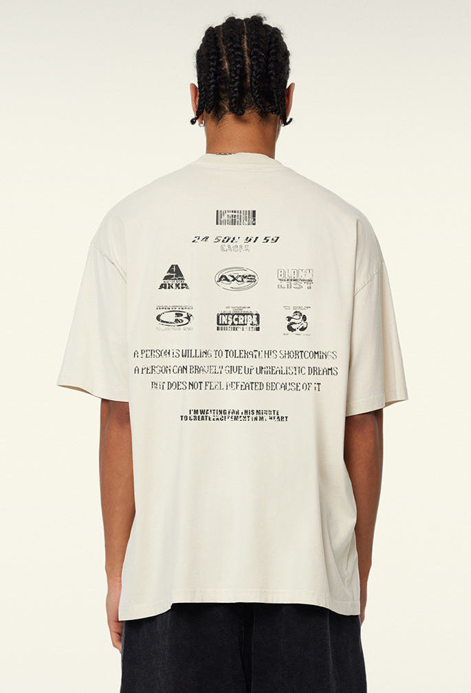 Back view of oversized graphic tee showing multiple printed logos and glitch text.