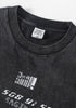 Close-up of collar tag reading “Designed by Be Thrived” on black washed tee.