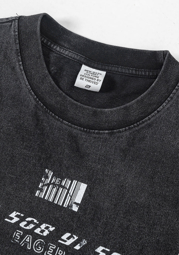 Close-up of collar tag reading “Designed by Be Thrived” on black washed tee.