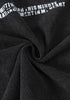 Black fabric twisted to show softness and stretch of cotton material.