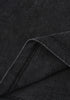 Detailed view of black washed cotton fabric with folded hem.