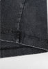 Zoomed-in look at double-stitched hem on washed black tee.