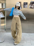Khaki wide-leg jeans with curved hem styled with off-shoulder denim crop top and baseball cap.