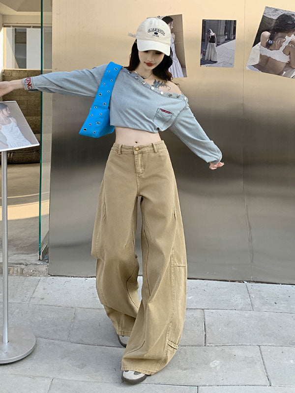 Khaki wide-leg jeans with curved hem styled with off-shoulder denim crop top and baseball cap.