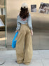 Back view of khaki wide-leg jeans with large pockets and relaxed fit.