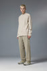 Man wearing khaki half zip long sleeve t shirt styled with beige pants