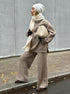 Side view of khaki half zip sweater 2 piece set styled with winter scarf