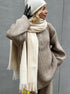 Side view of woman in khaki half zip sweater 2 piece set with scarf and wide leg pants