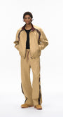Khaki tracksuit front view, jacket open over tee, wide leg pants