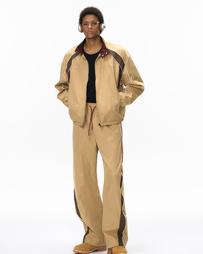 Khaki tracksuit front view, jacket open over tee, wide leg pants