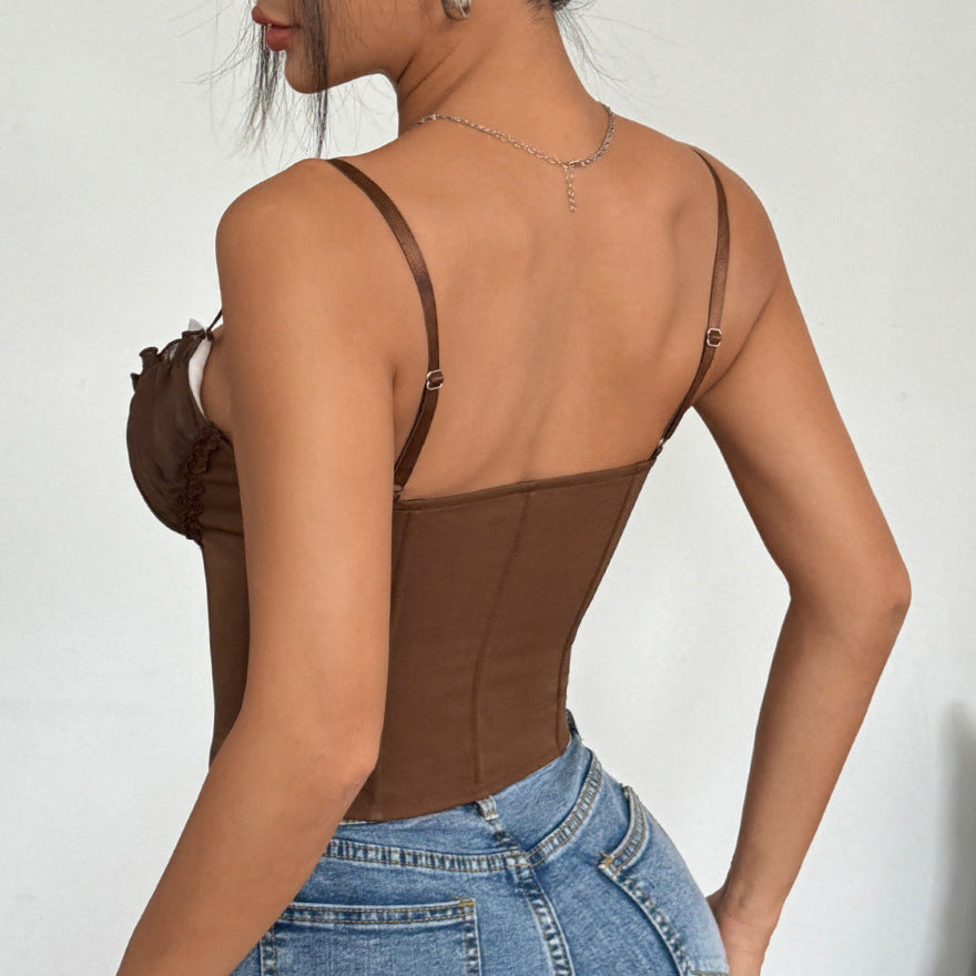 Woman wearing a brown lace corset top and blue jeans, shown from the back.