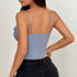 Woman wearing a light blue lace corset top and black jeans, shown from the back.