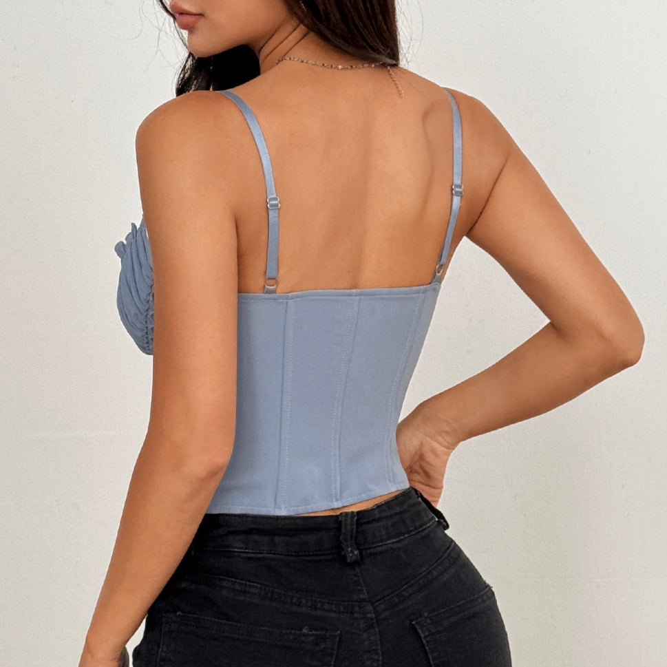 Woman wearing a light blue lace corset top and black jeans, shown from the back.