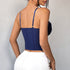 Back view of navy blue corset with adjustable straps and white skirt.