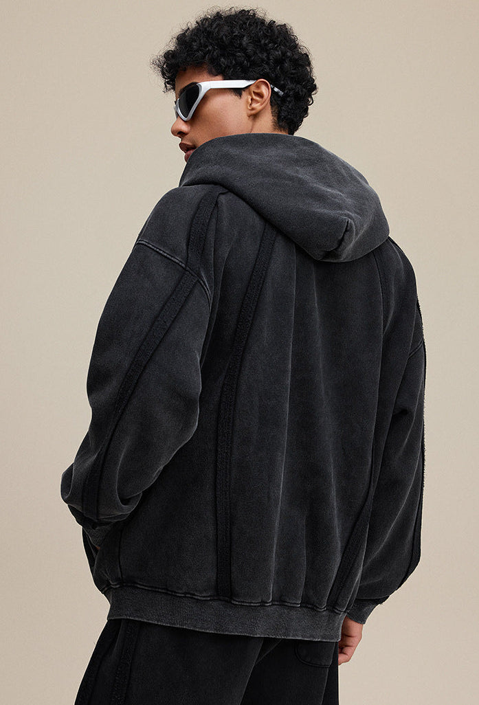 Back view of black zip hoodie with oversized hood and rib hem