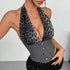 Close-up of woman wearing a gray leopard print halter corset top with gray boned bodice.