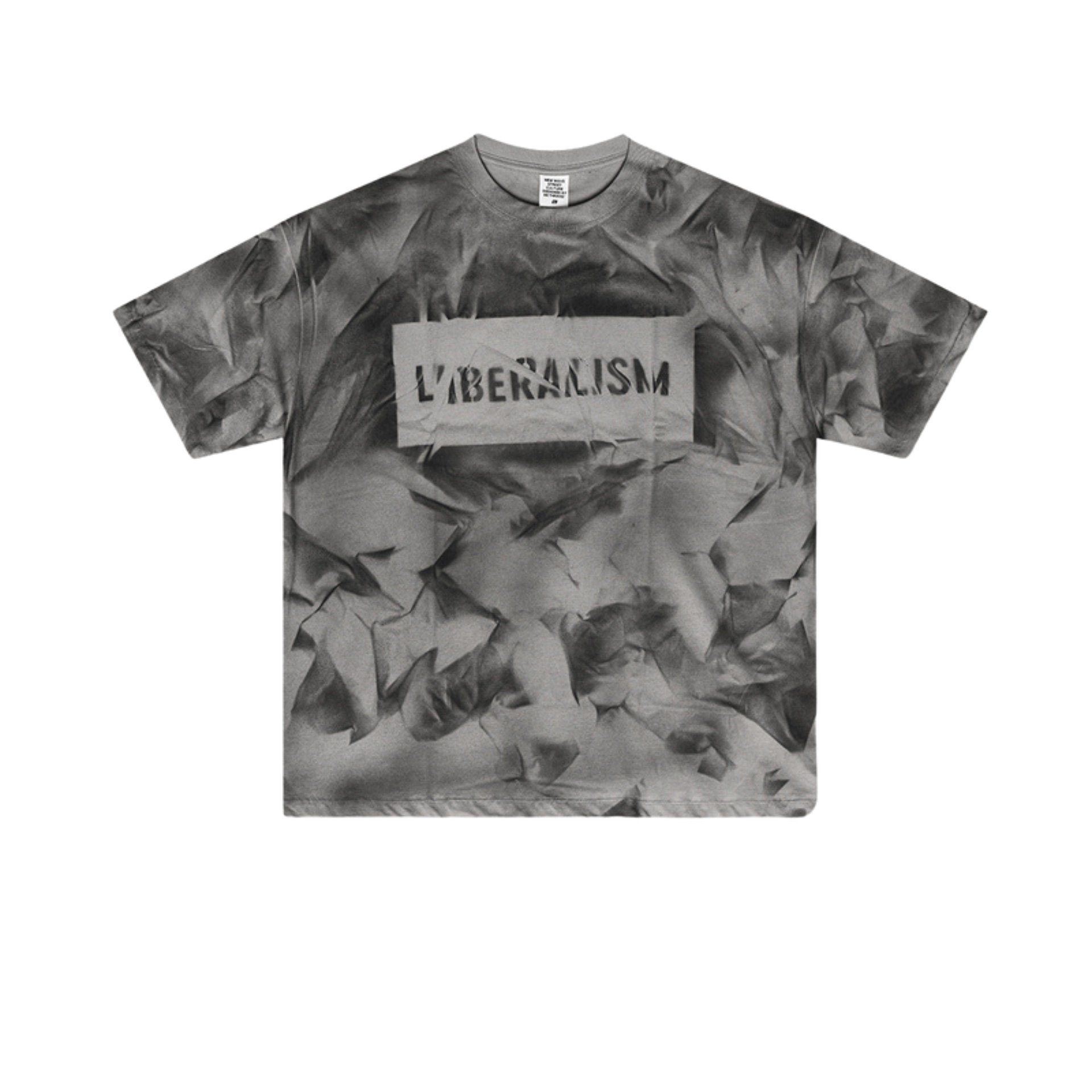 Flat lay of gray graphic tee with black “LIBERALISM” stencil text and abstract texture.