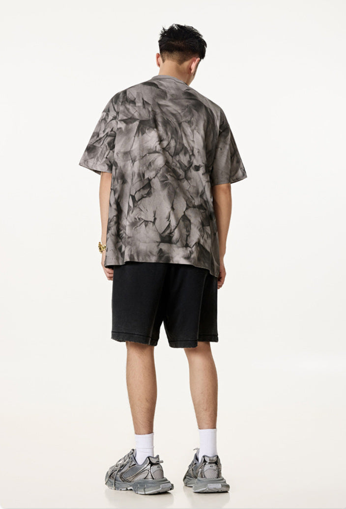 Model wearing grey Liberalism tee from the back, showing full rear abstract design.