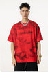 Model wearing red Liberalism tee, standing straight with bold chain necklace and streetwear style.