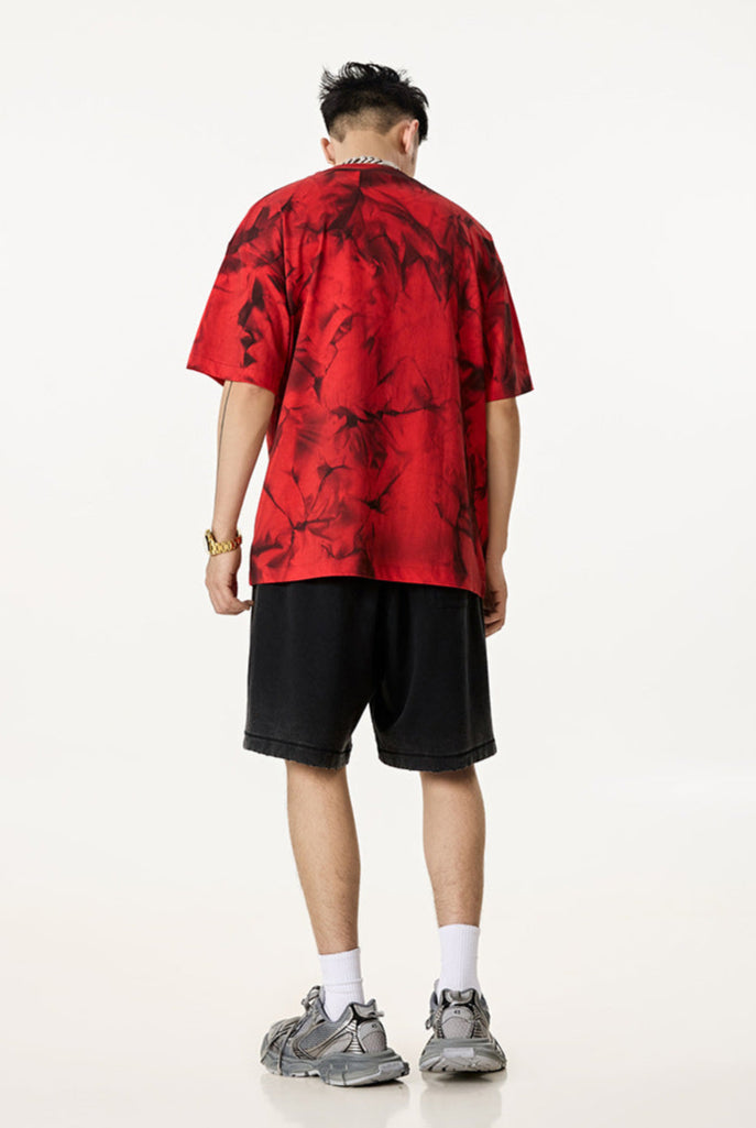 Model in red Liberalism tee facing away, showing full back and abstract print.