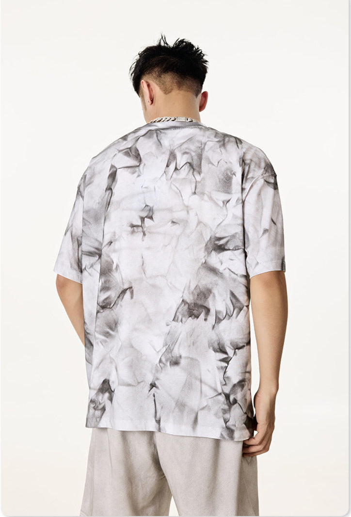 Back view of man wearing white “Liberalism” graphic tee.
