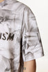 Close-up of white tee sleeve and partial “Liberalism” print.