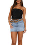 Model in a black strapless top, light blue denim mini skirt, and leopard print belt.