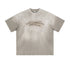Light gray oversized tee with motivational quote in black, displayed on textured background.