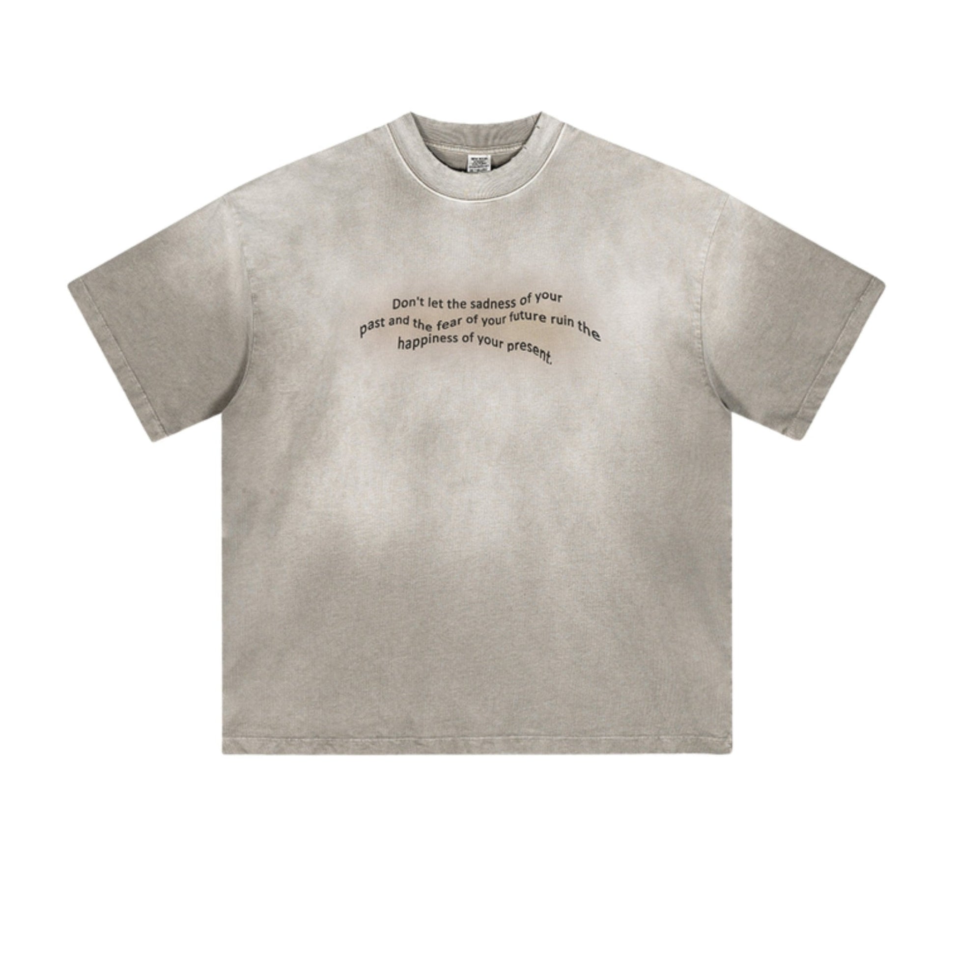 Light gray oversized tee with motivational quote in black, displayed on textured background.