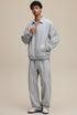 Model in light gray collared zip sweatshirt, full front