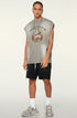 Model in light grey ram tee and black shorts with white sneakers