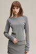 Close-up cuff and hem detail of light gray women’s long sleeve tee