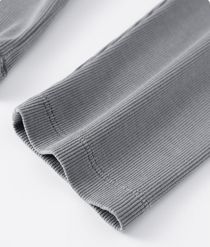 Fabric texture close-up of light gray women’s long sleeve tee