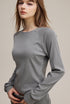 Model wearing light gray women’s long sleeve tee front view