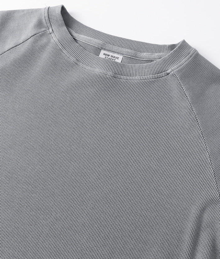 Close-up neckline detail of light gray women’s long sleeve tee