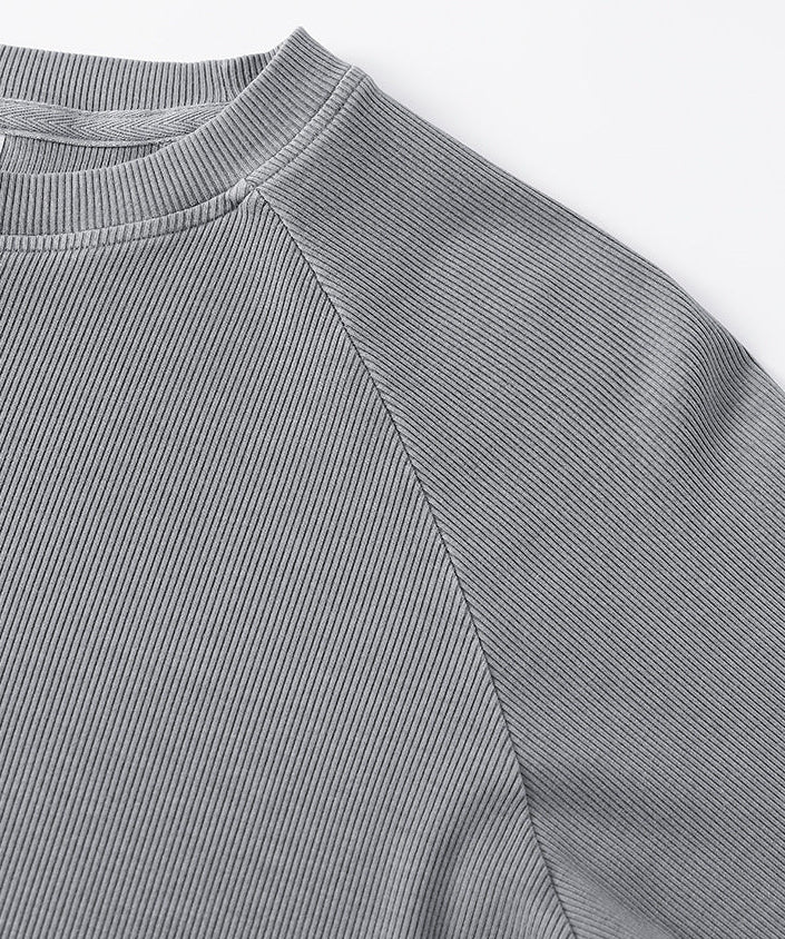 Shoulder seam detail of light gray women’s long sleeve tee