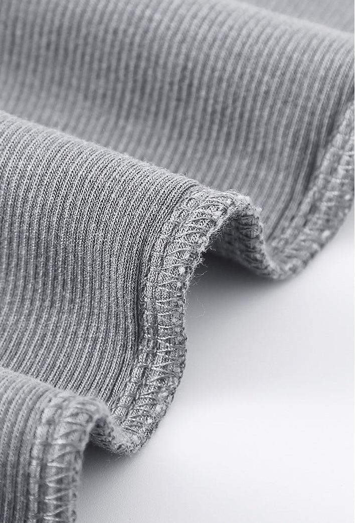 Edge stitching close-up of light gray ribbed long sleeve tee fabric