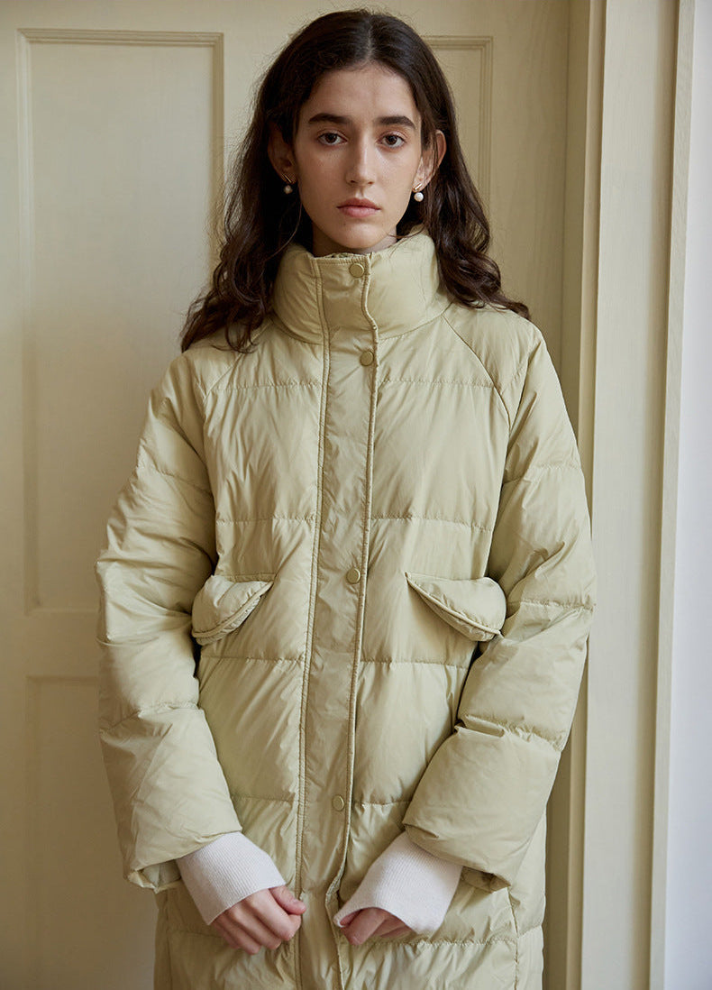 Pocket and sleeve detail of light green long puffer coat for women